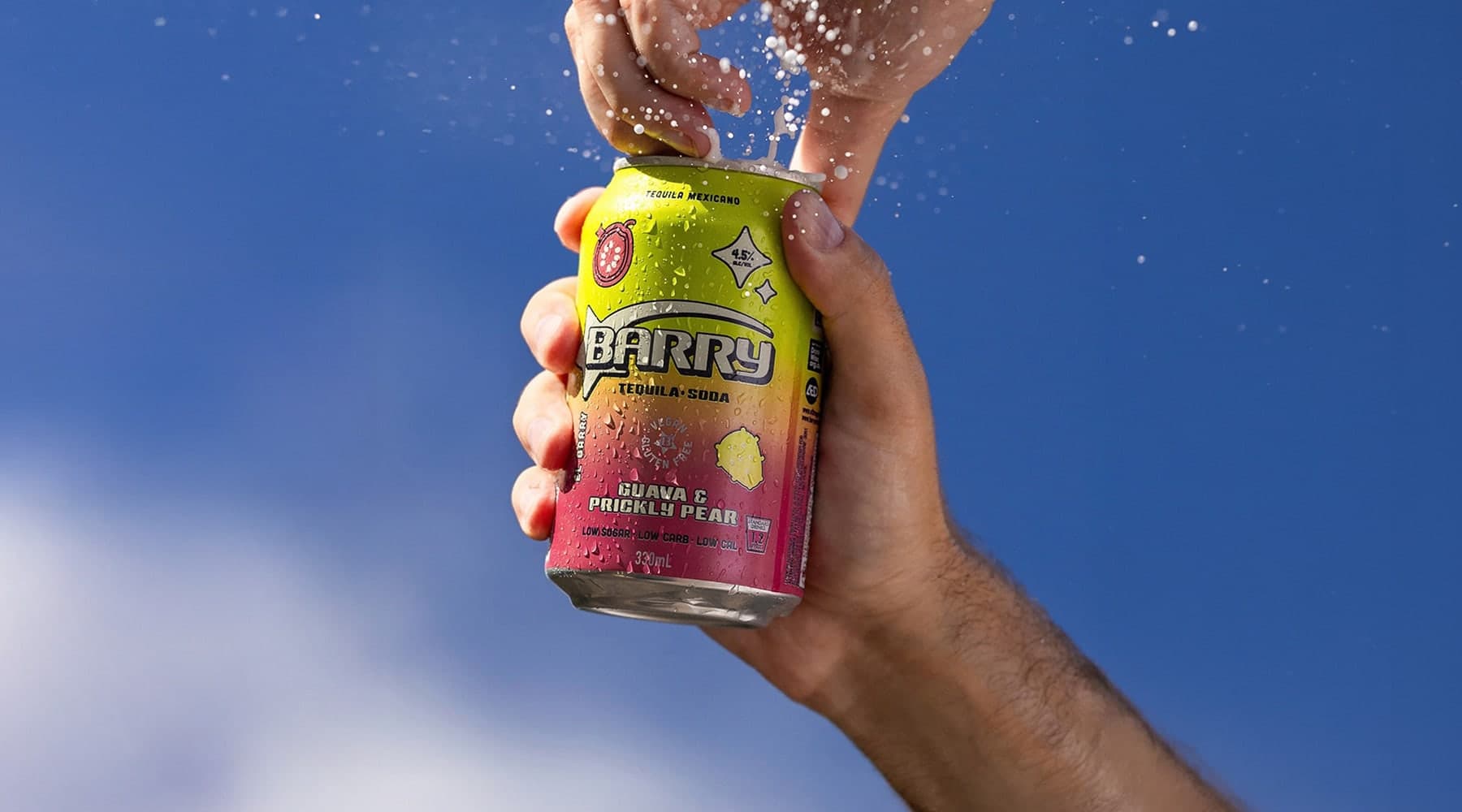 A Barry tequila soda can cracked open against a blue sky