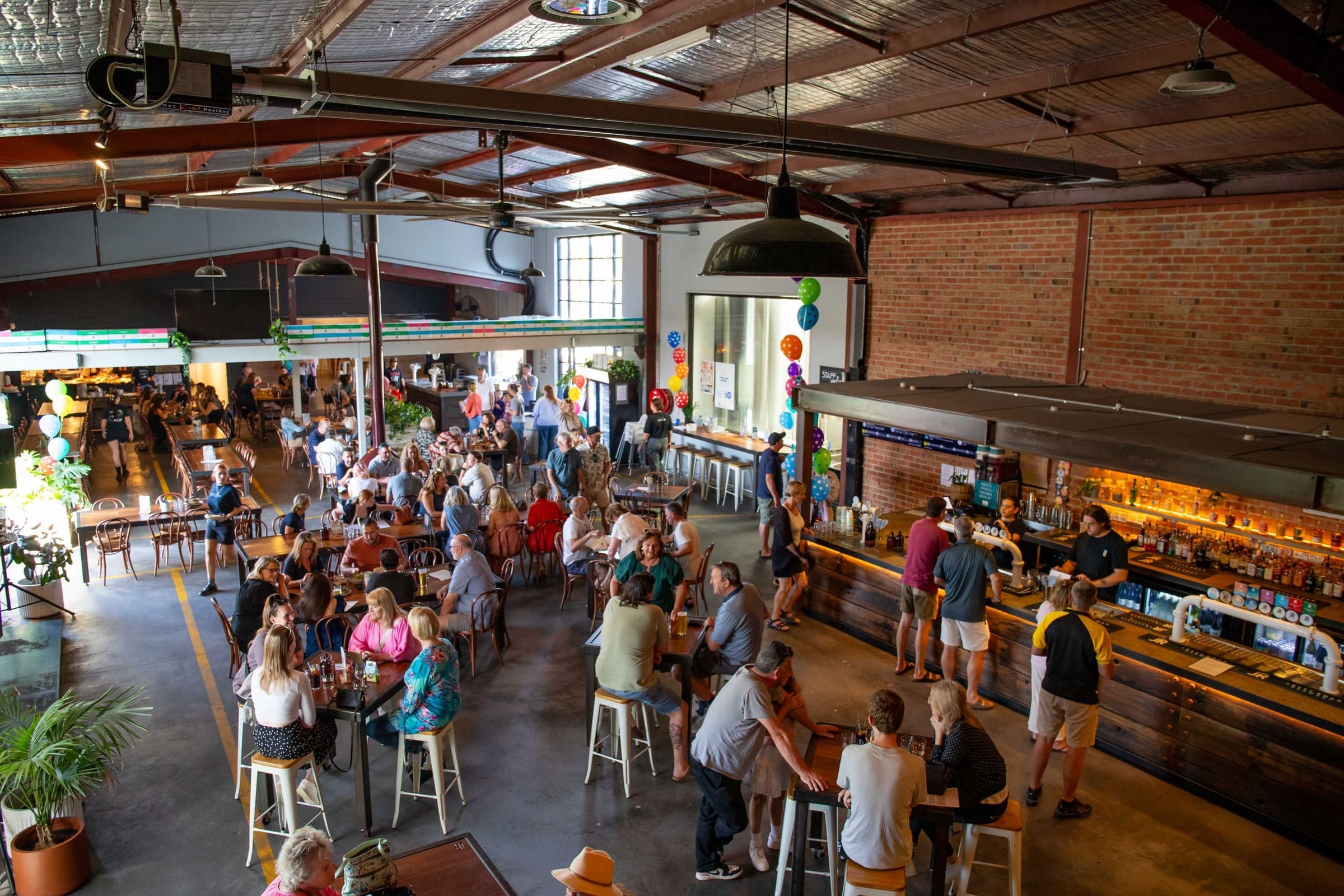 A packed brewpub bar on a Saturday afternoon