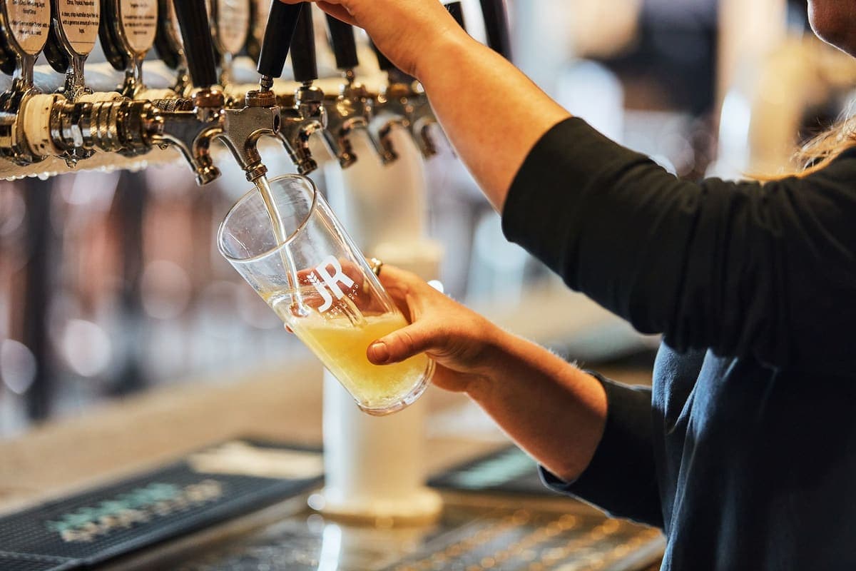 A pint being poured from the taps