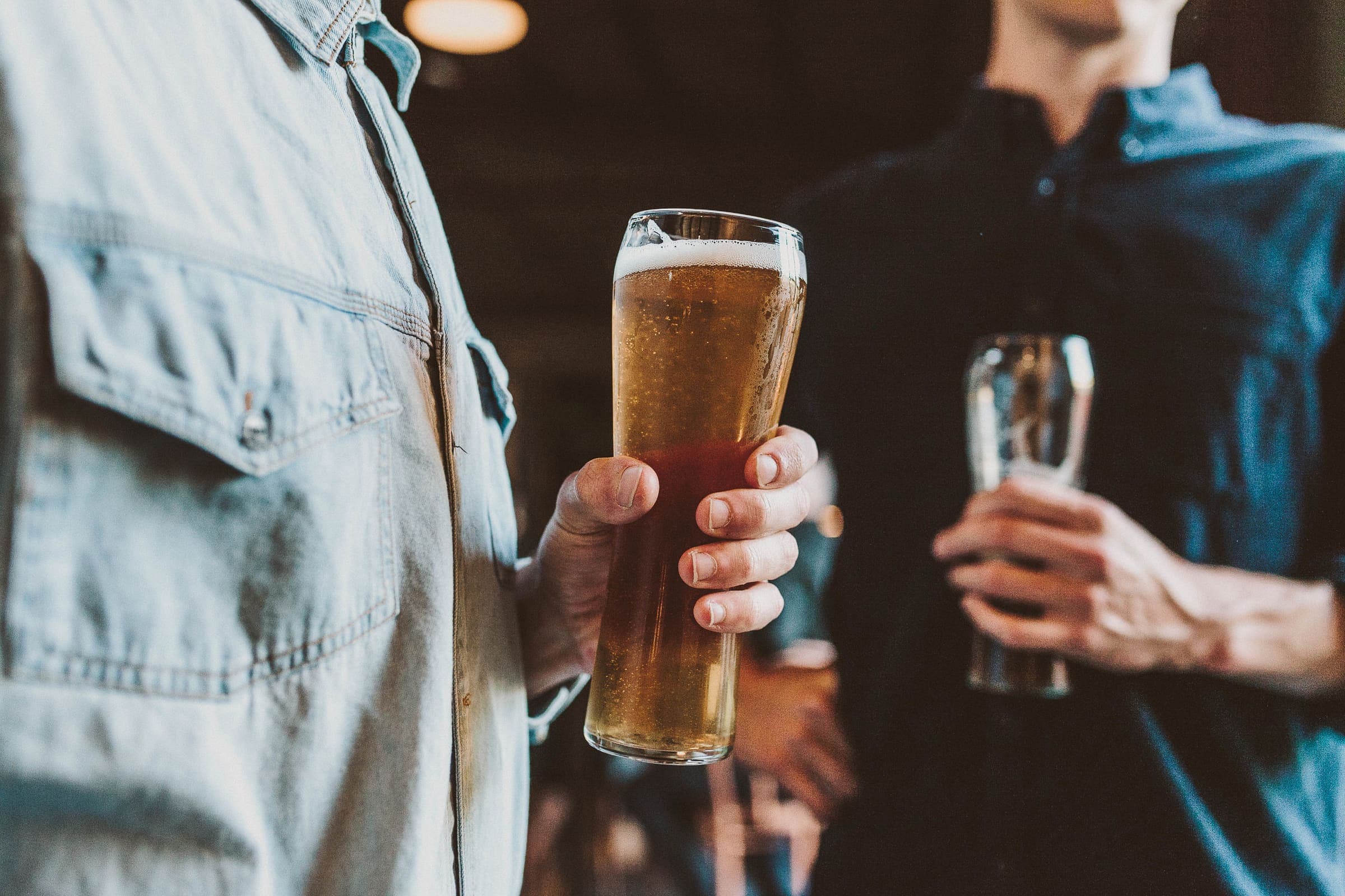 Two pints of lager held at the bar